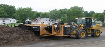Township staff turning leaf compost with WILDCAT Compost Turner